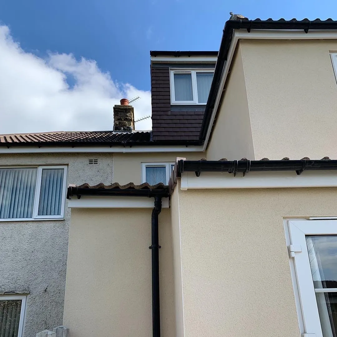 New white UPVC guttering and fascia boards on a brick house